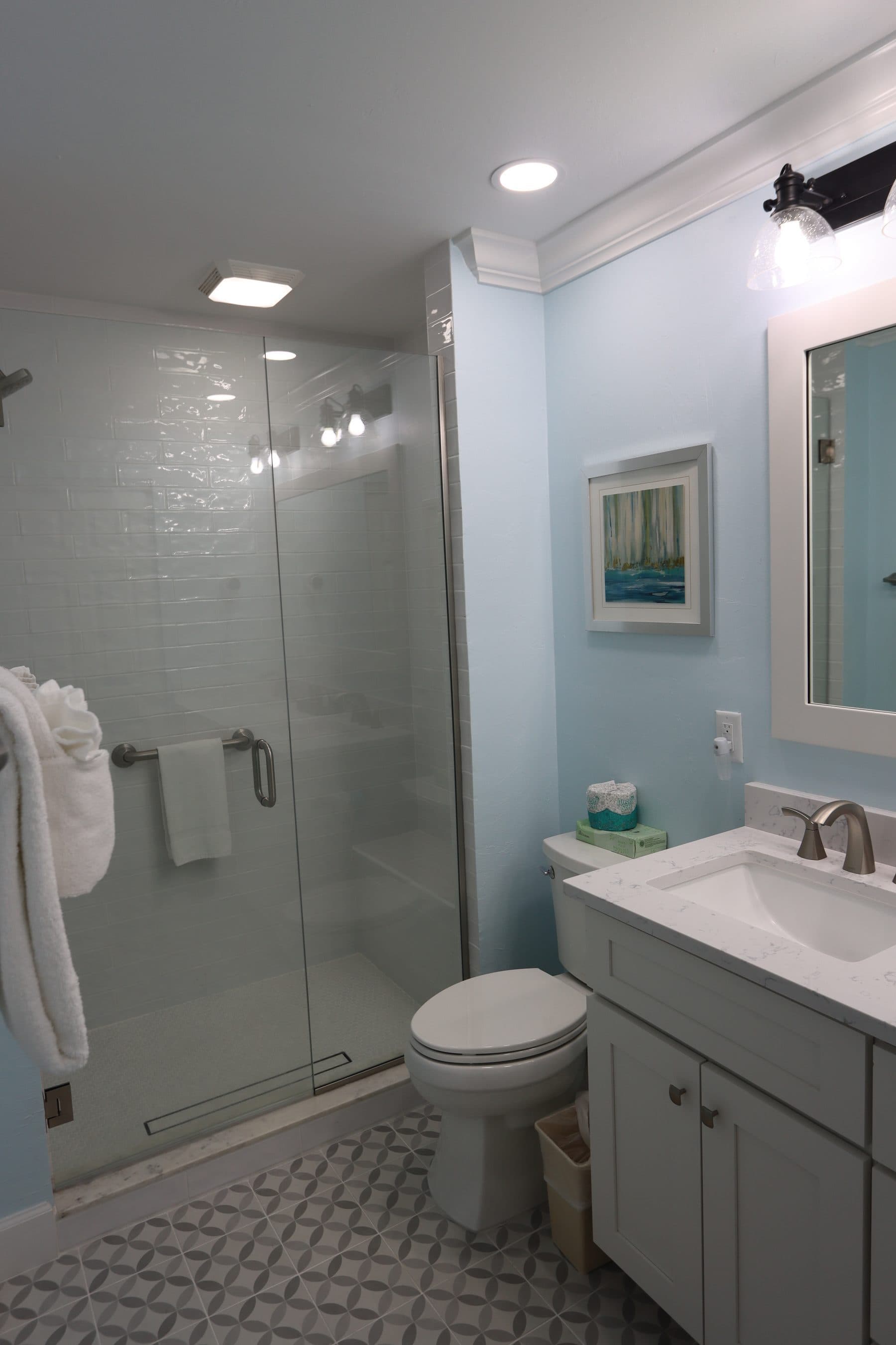 Bathroom with glass shower and subway tile floor