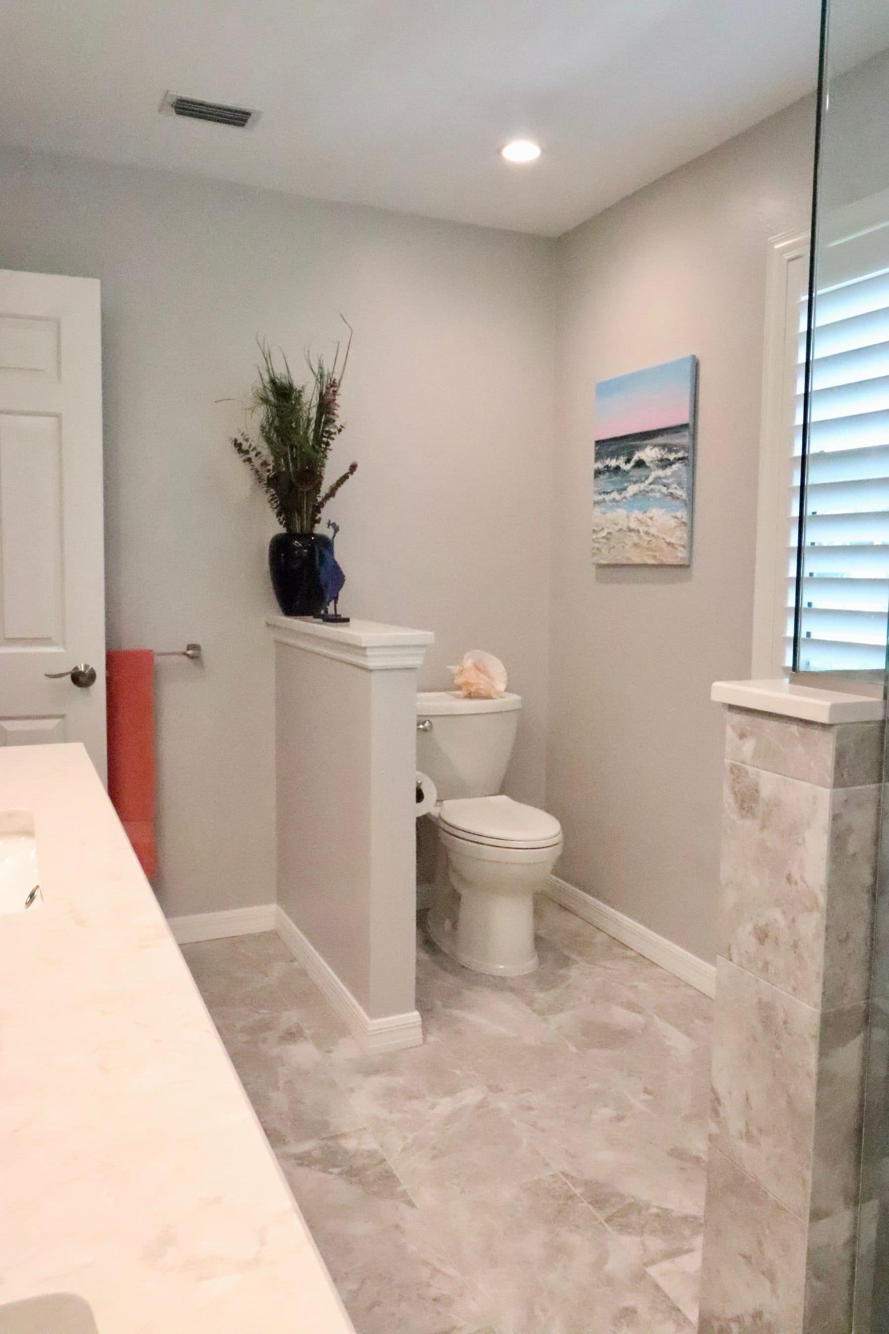 Finished bathroom with coastal decor and toilet nook