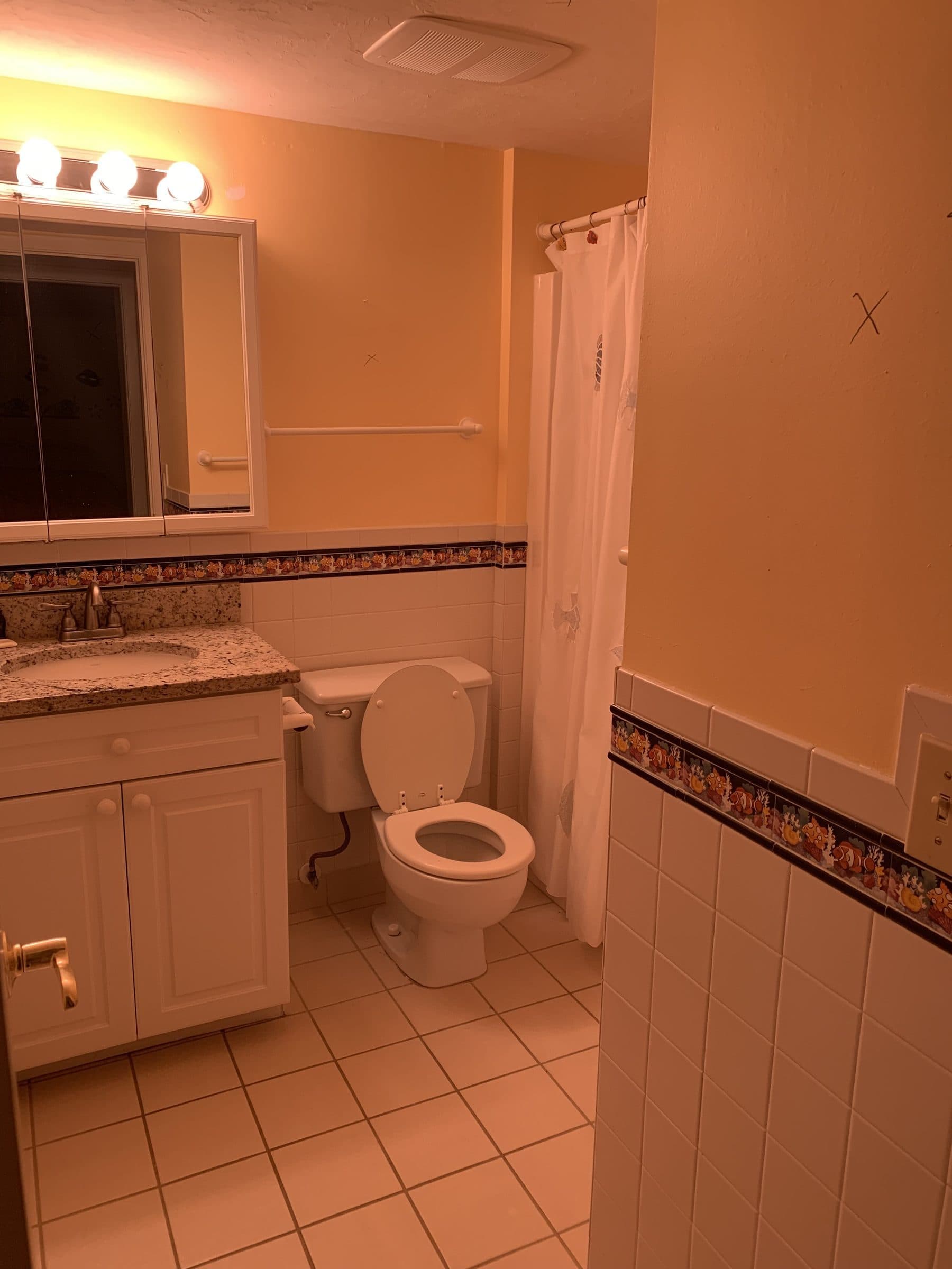 Dated bathroom with peach tile and tub