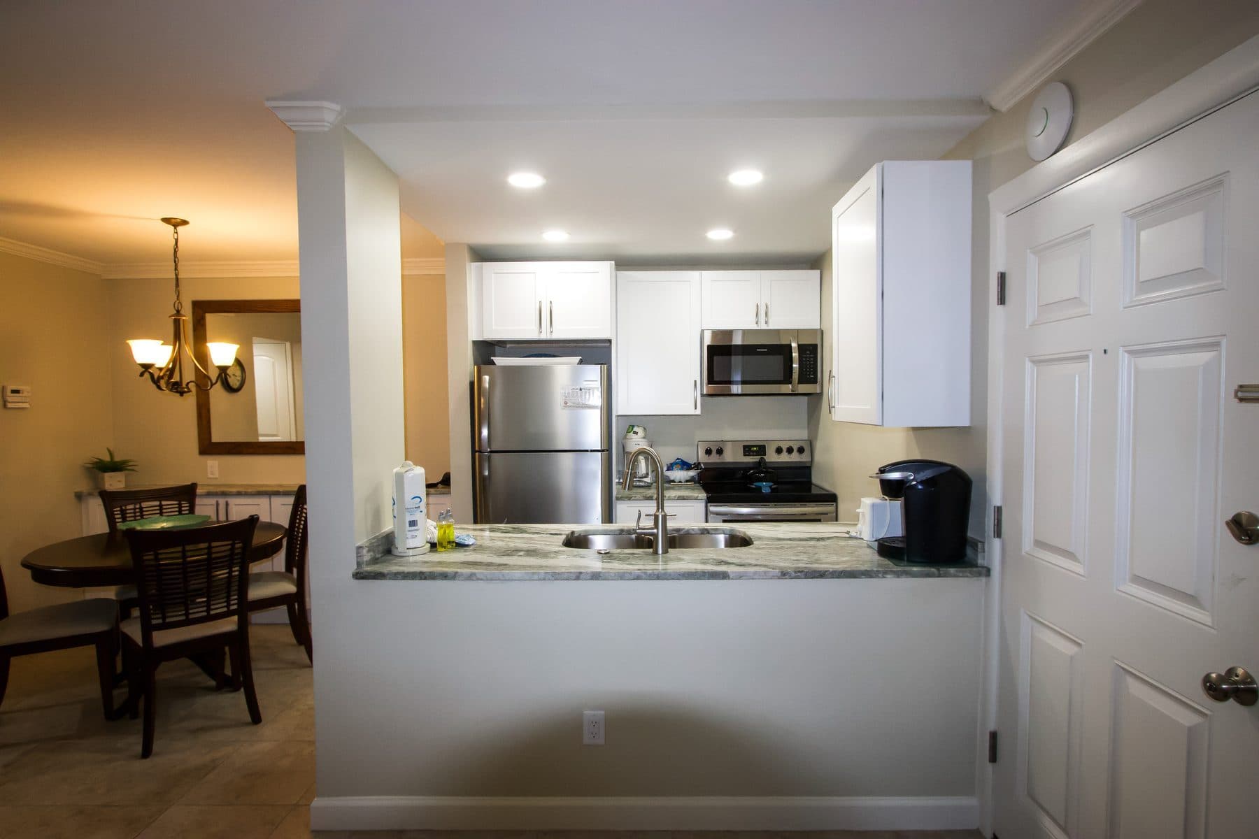 Finished white kitchen open to dining area