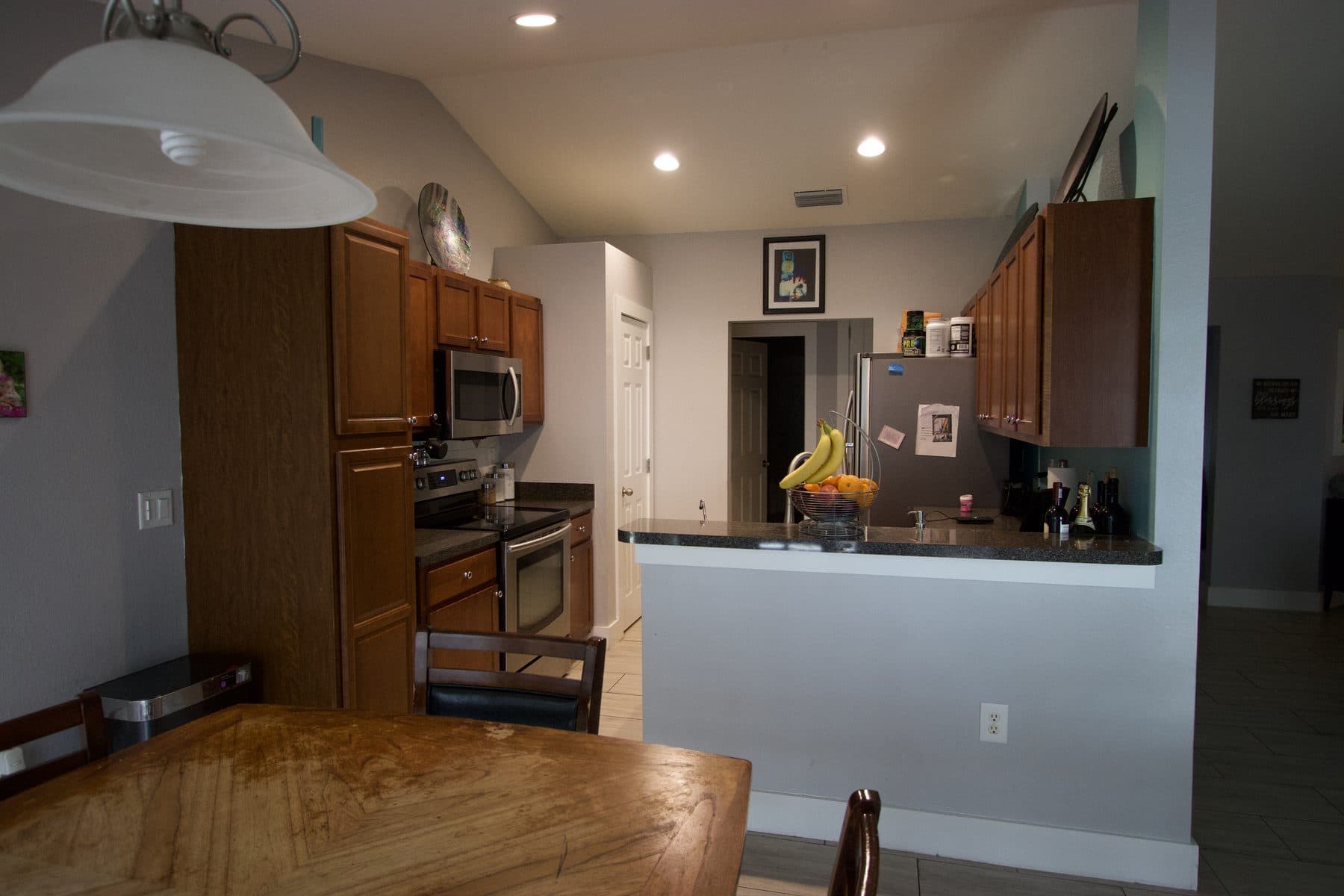 Finished kitchen with oak cabinetry and stainless appliances
