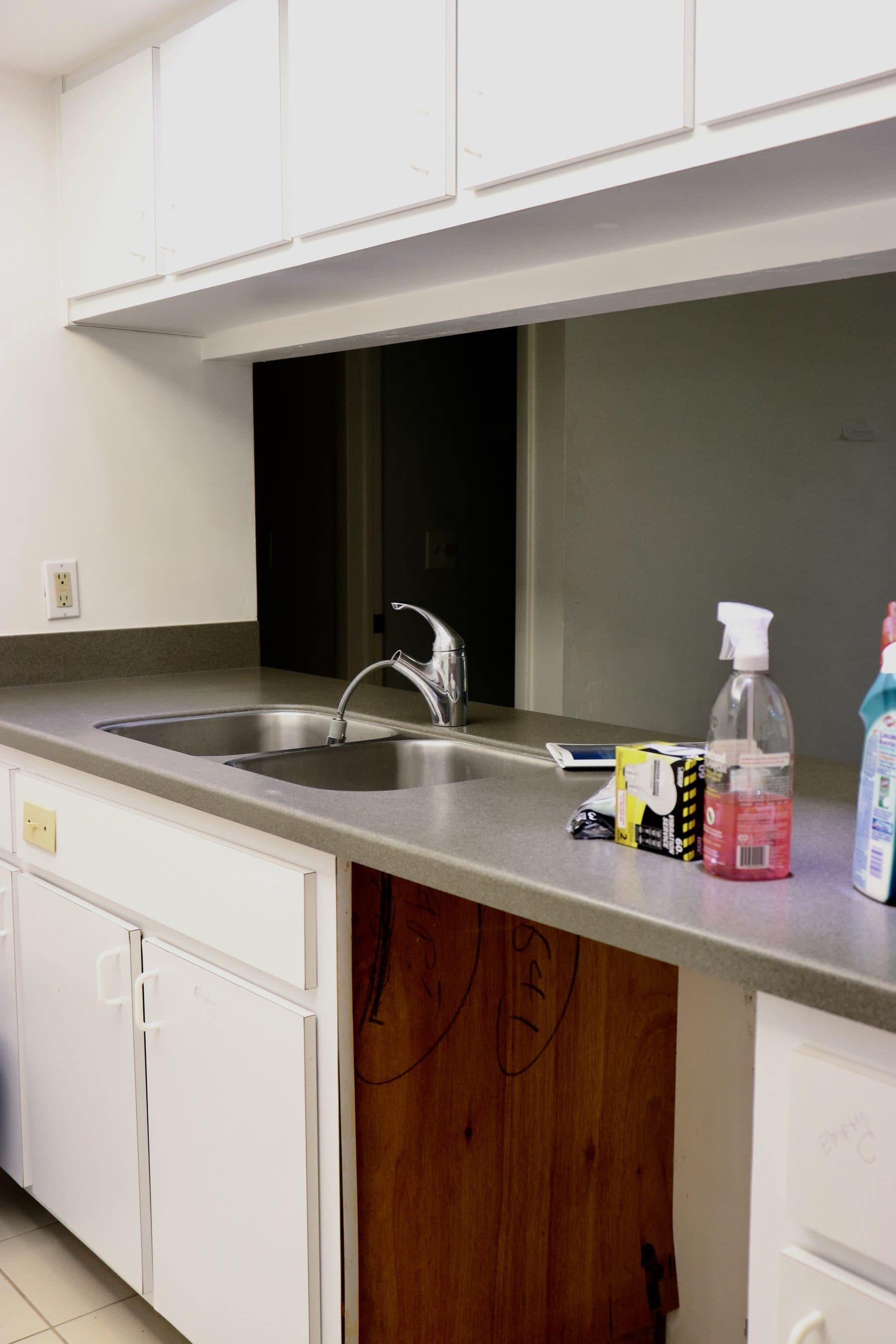 Kitchen mid-demolition with bare countertop