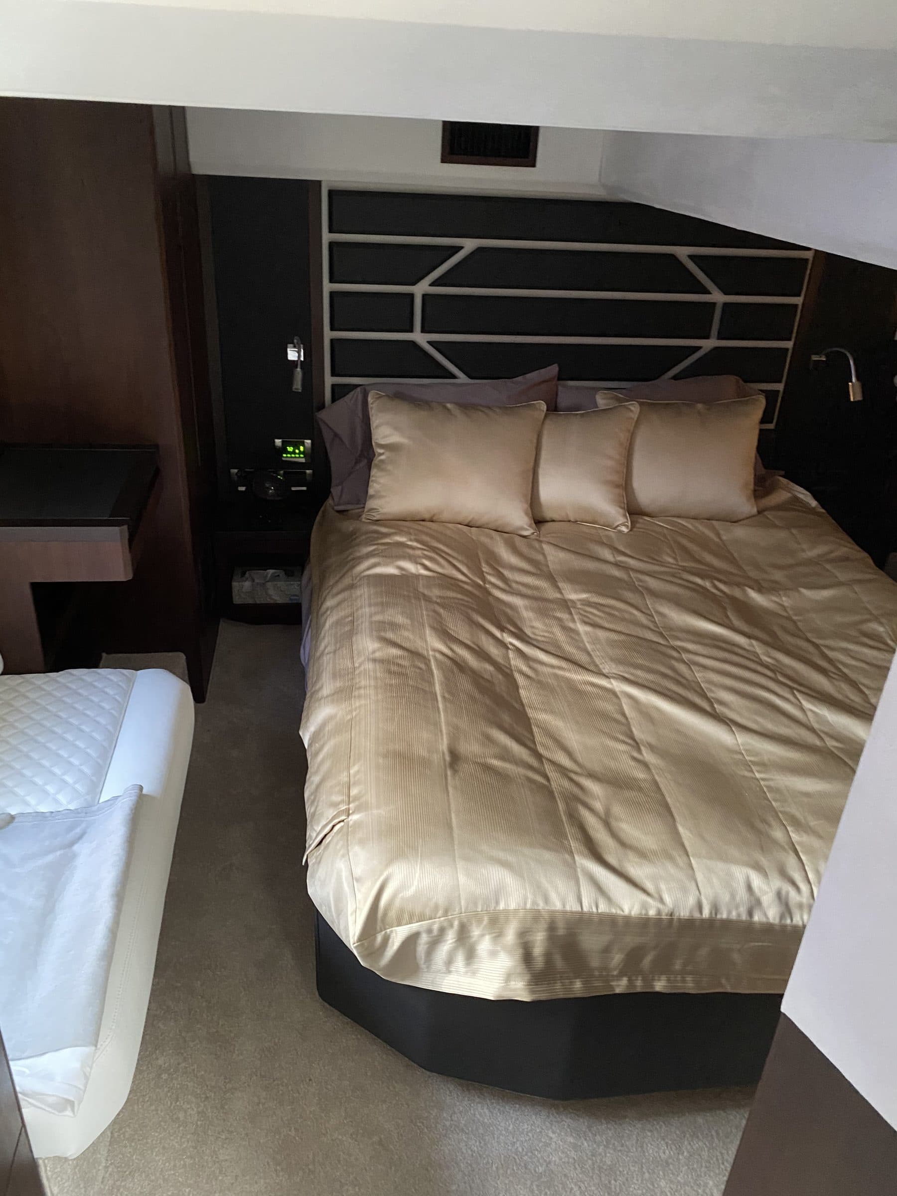 Boat cabin berth with upholstered bedding