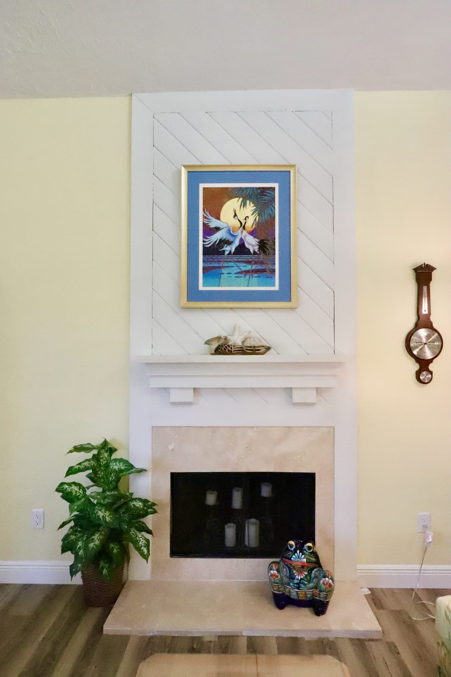 Fireplace with framed art above the mantel