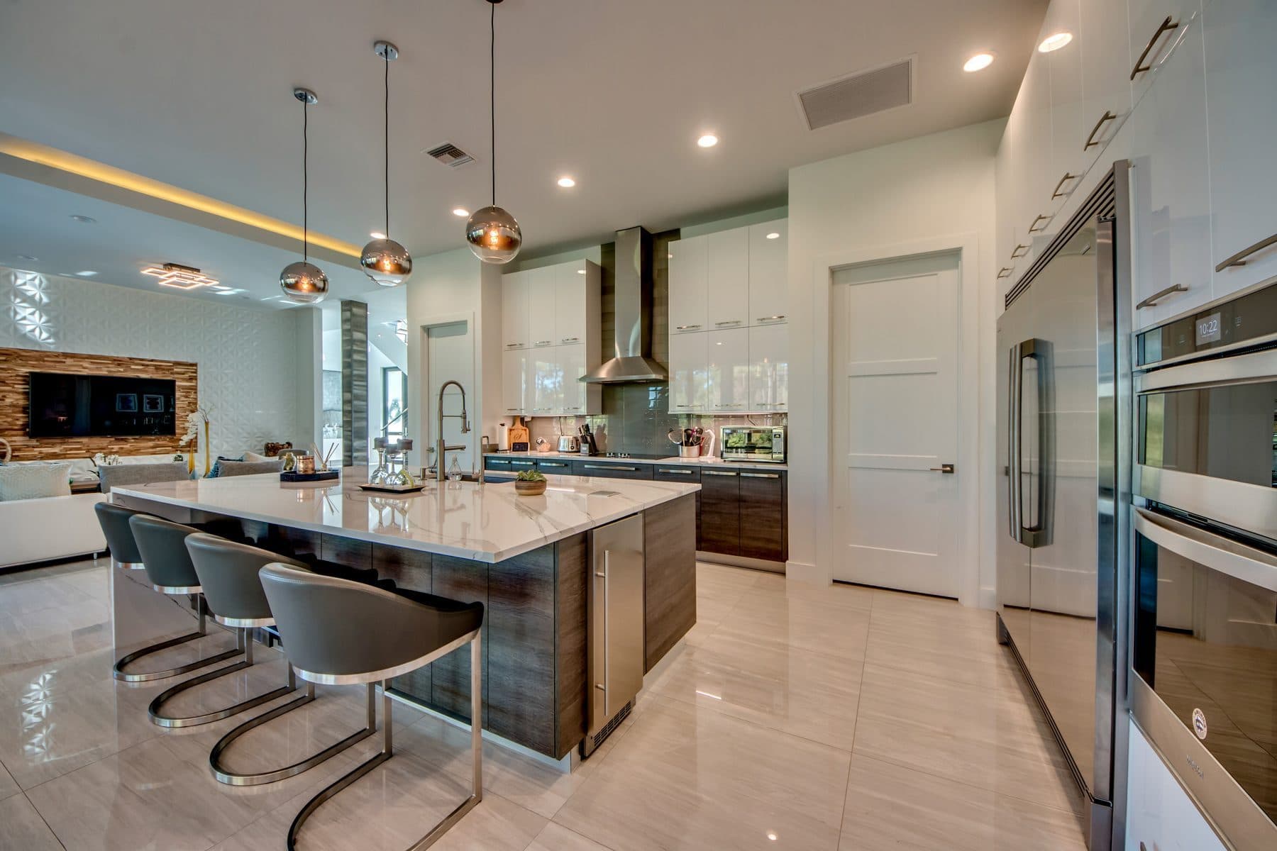 Kitchen with blue island and pendant lighting