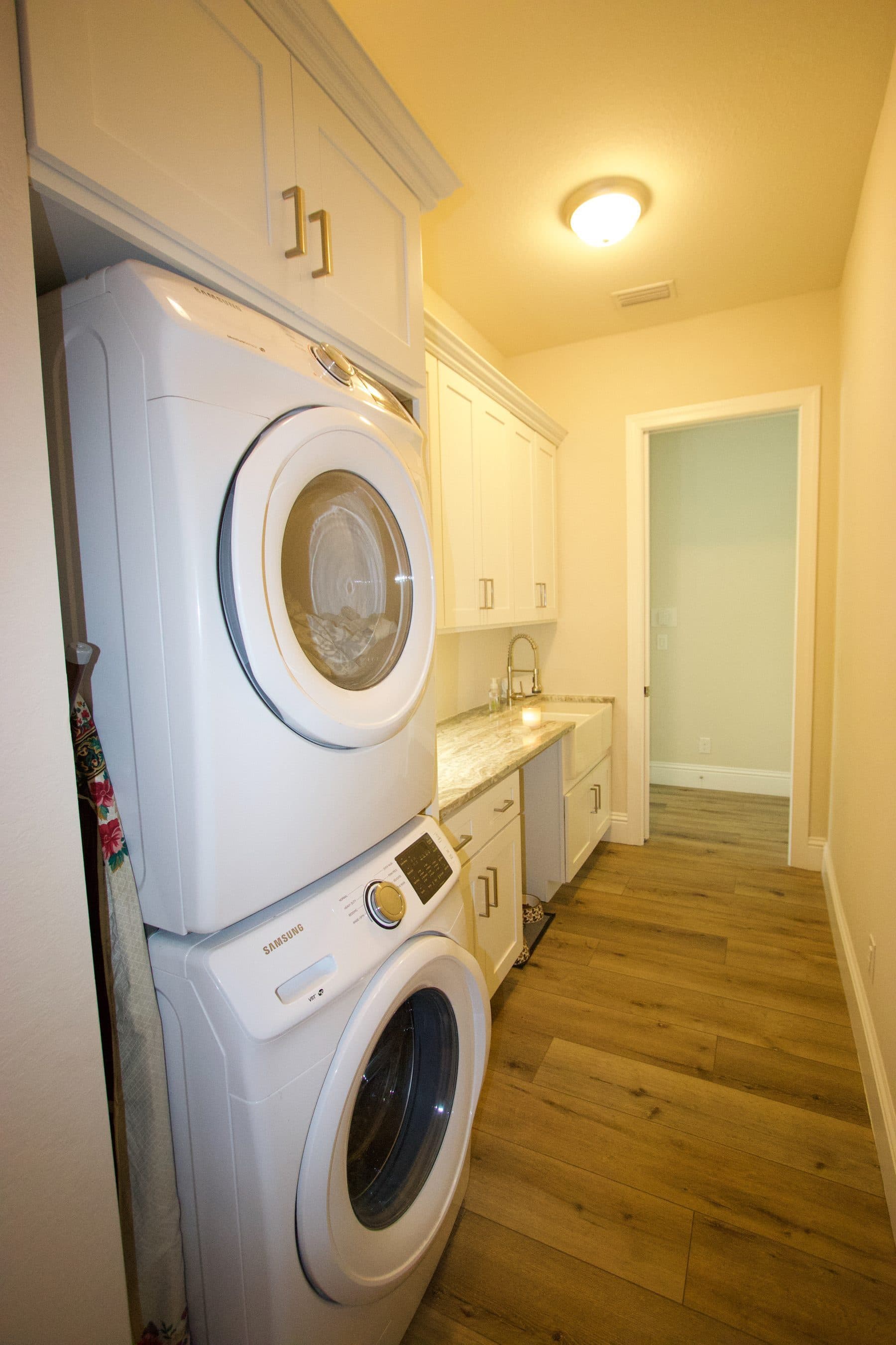 Stacked washer and dryer in a hallway nook