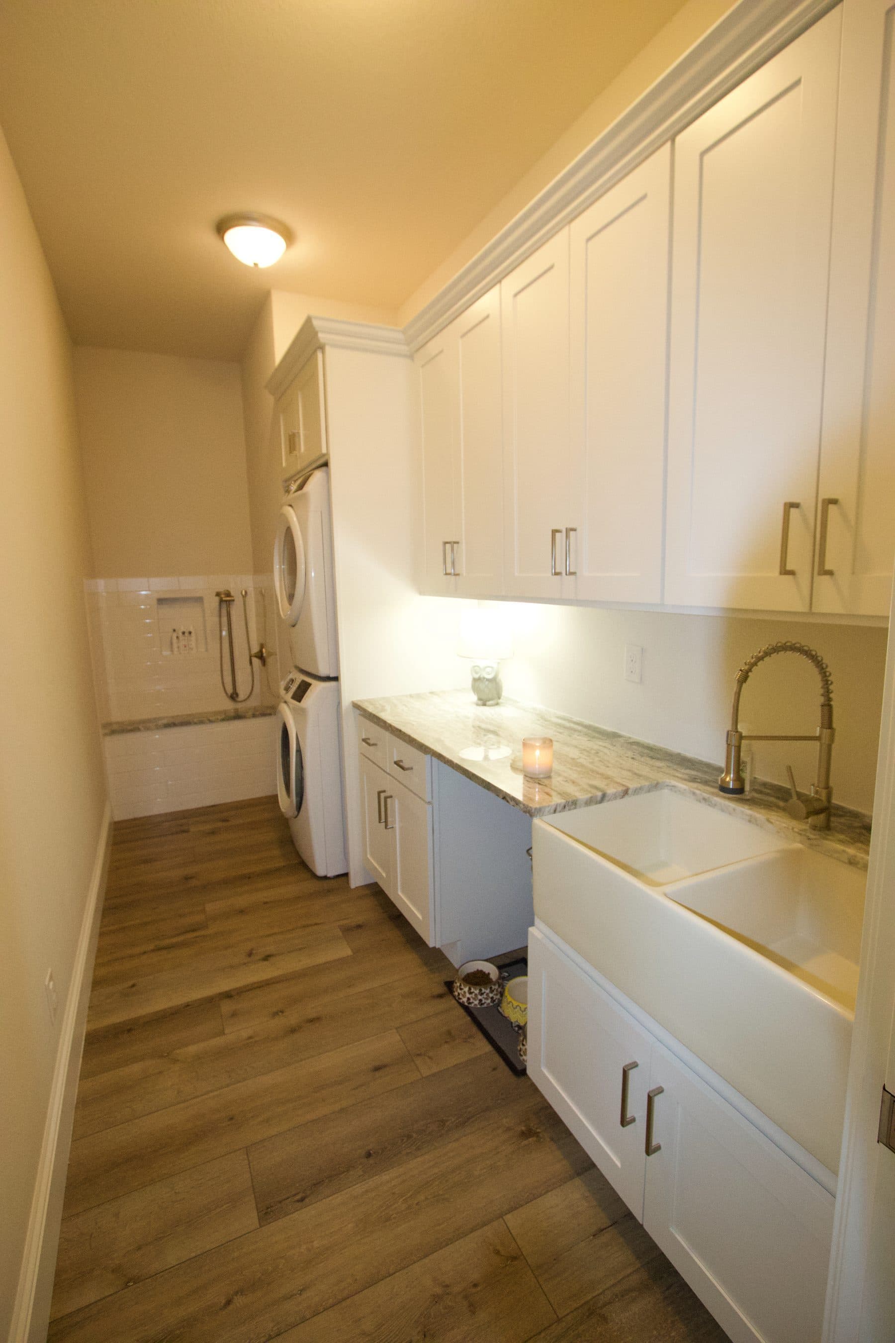 Laundry room with white cabinetry and counters