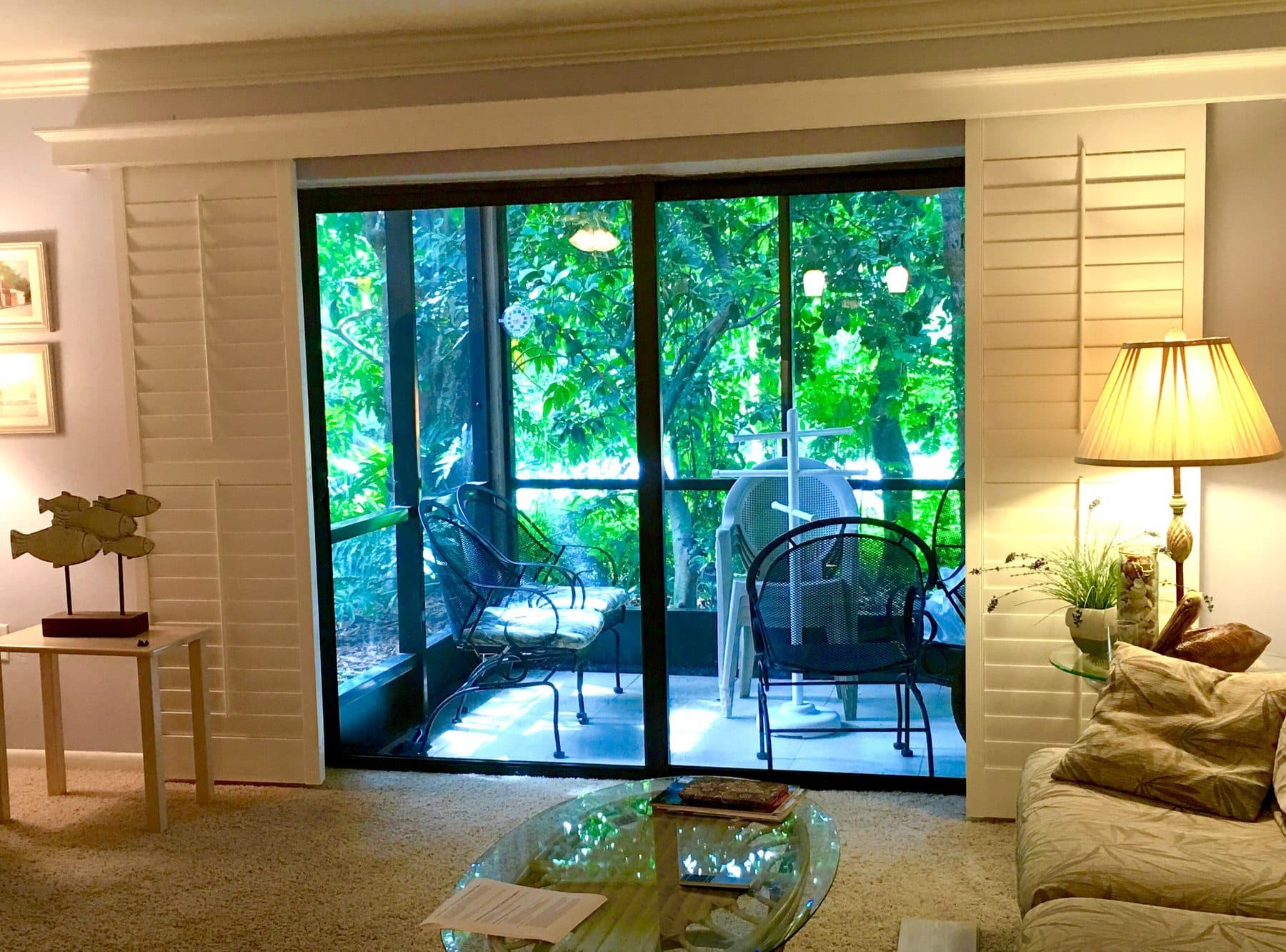 Plantation shutters on a sliding glass door to a patio