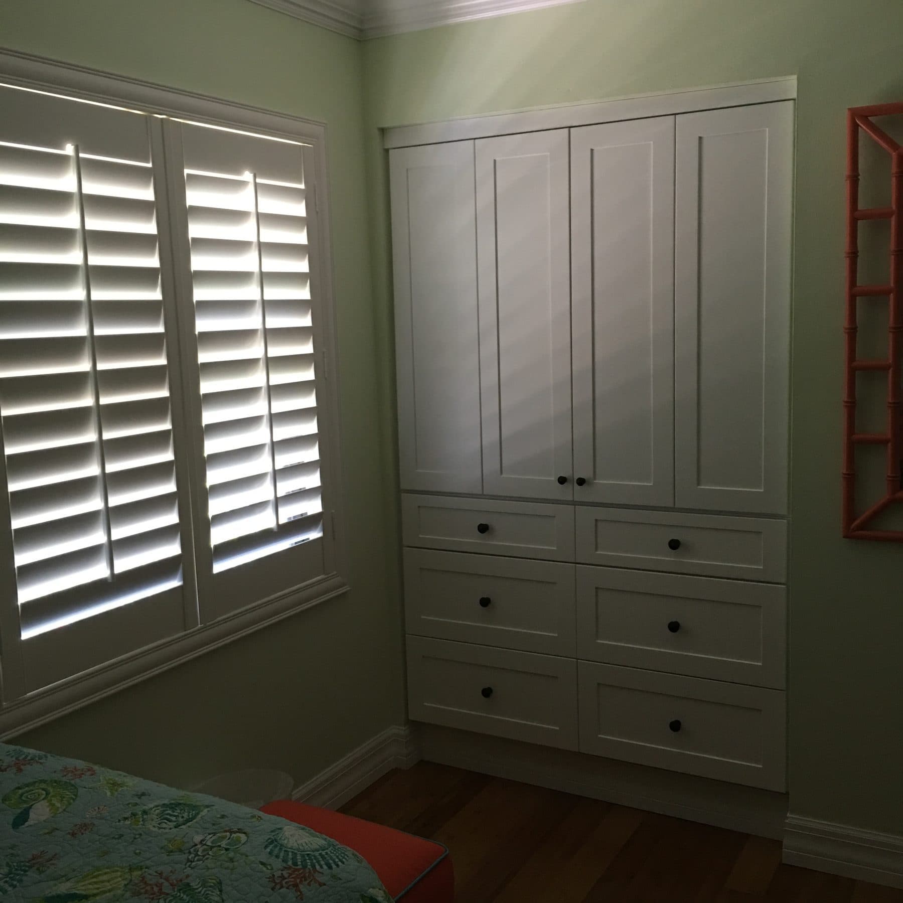 Bedroom built-in dresser with plantation shutters