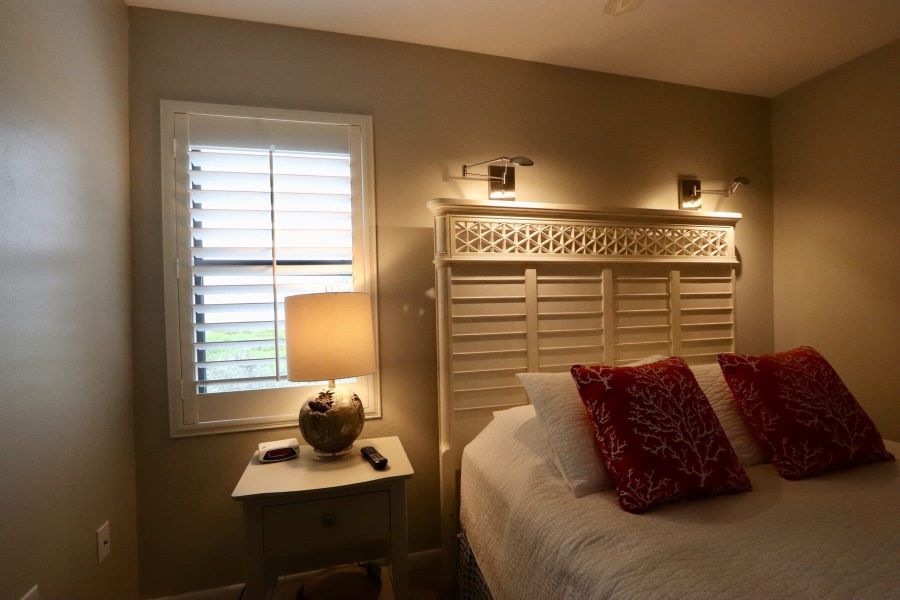 Bedroom with plantation shutters and headboard