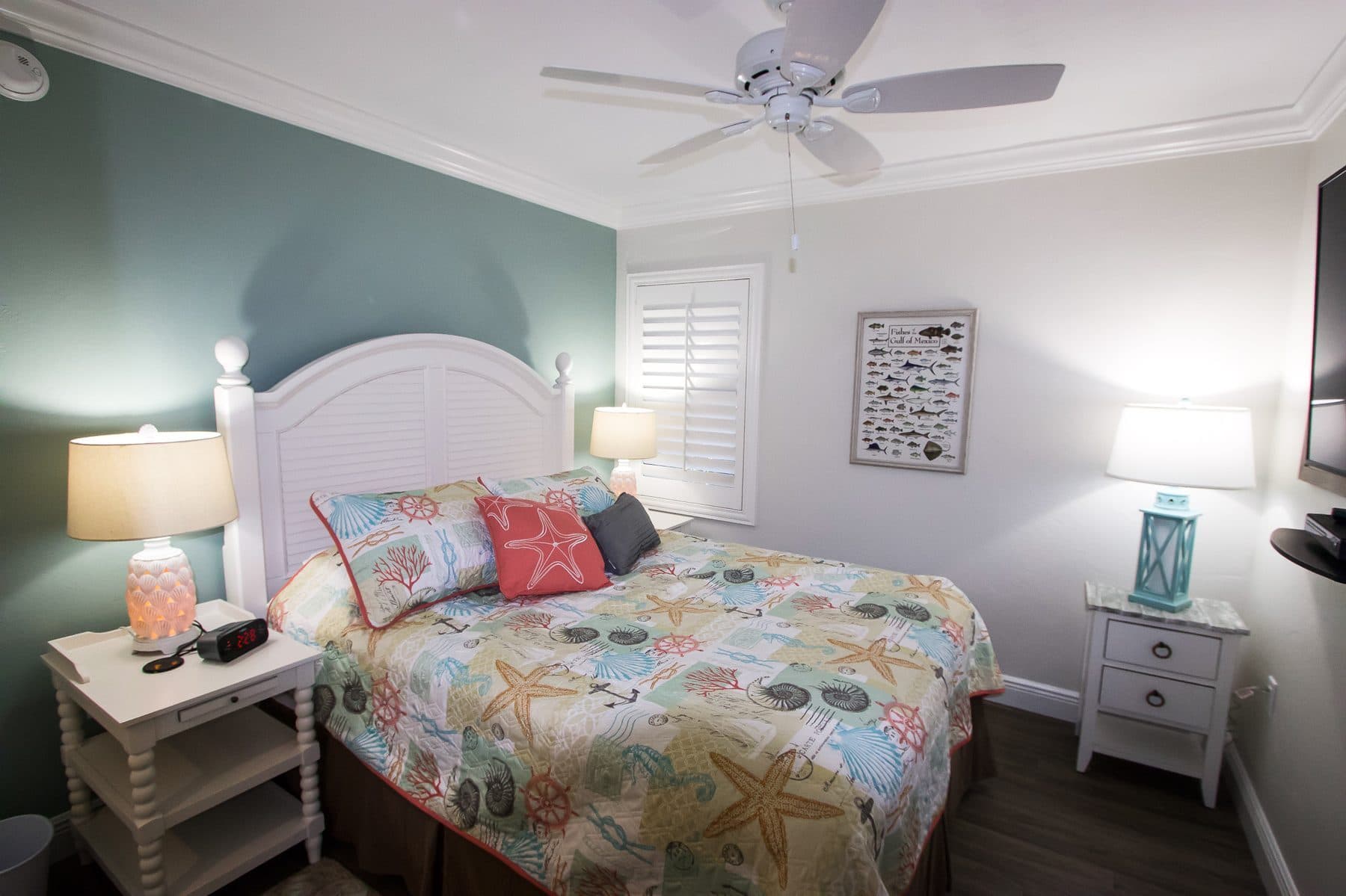 Bedroom with plantation shutters and reading lamps