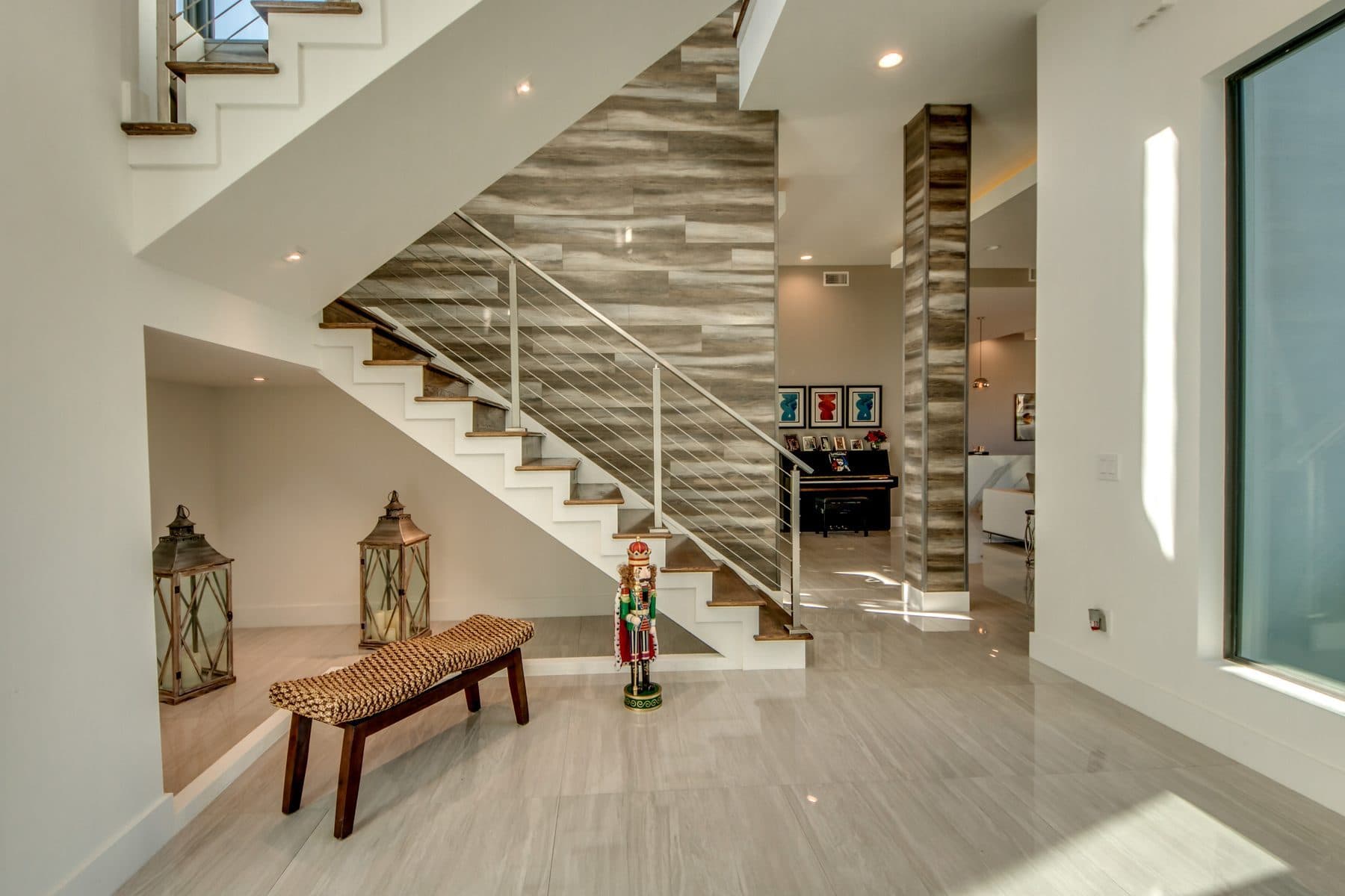 Curved staircase with wood and iron railing beneath a skylight