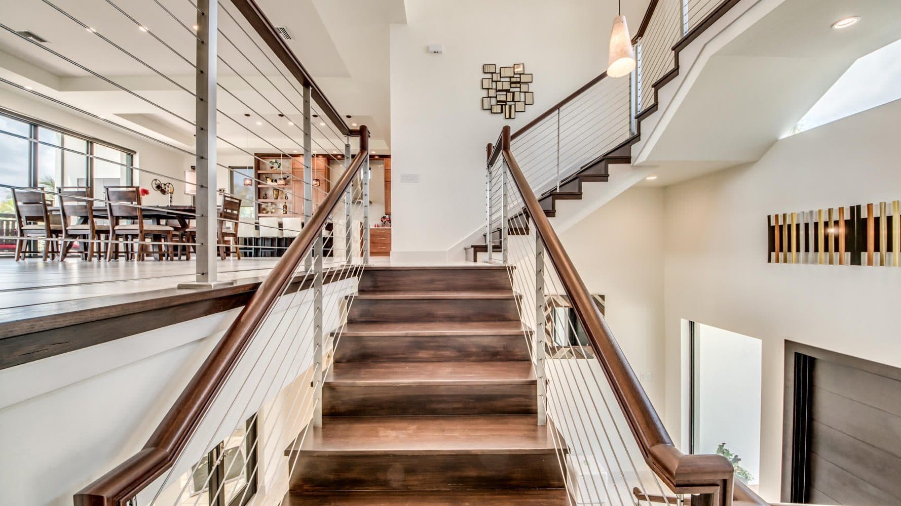 Staircase with cable railing in a bright entryway